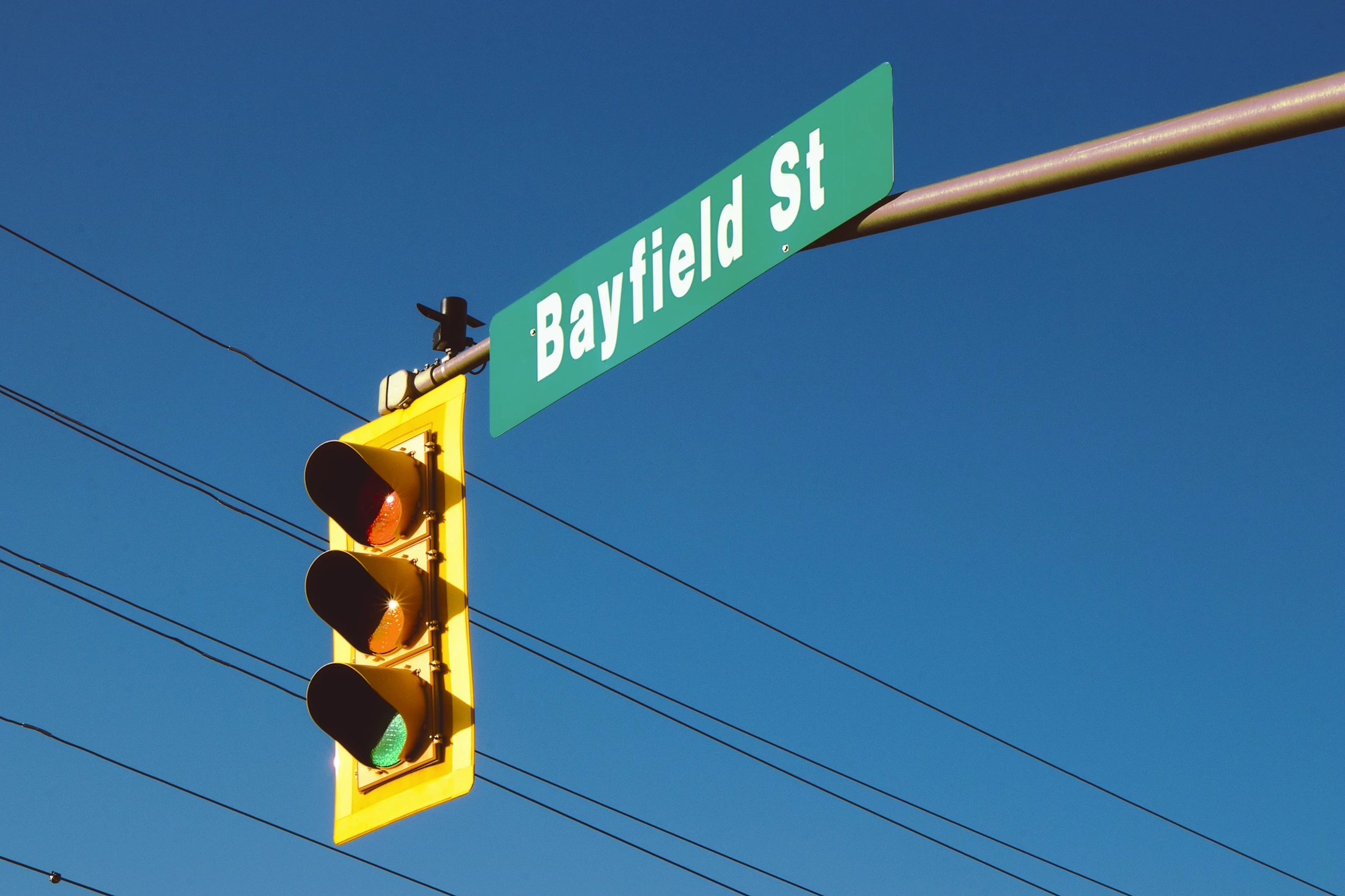 A Bayfield Street sign above a traffic light in downtown Barrie