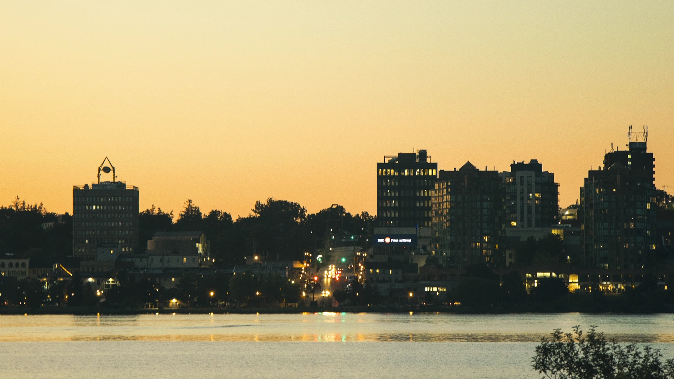 Downtown Barrie's skyline reflected on Kempenfelt Bay at dusk