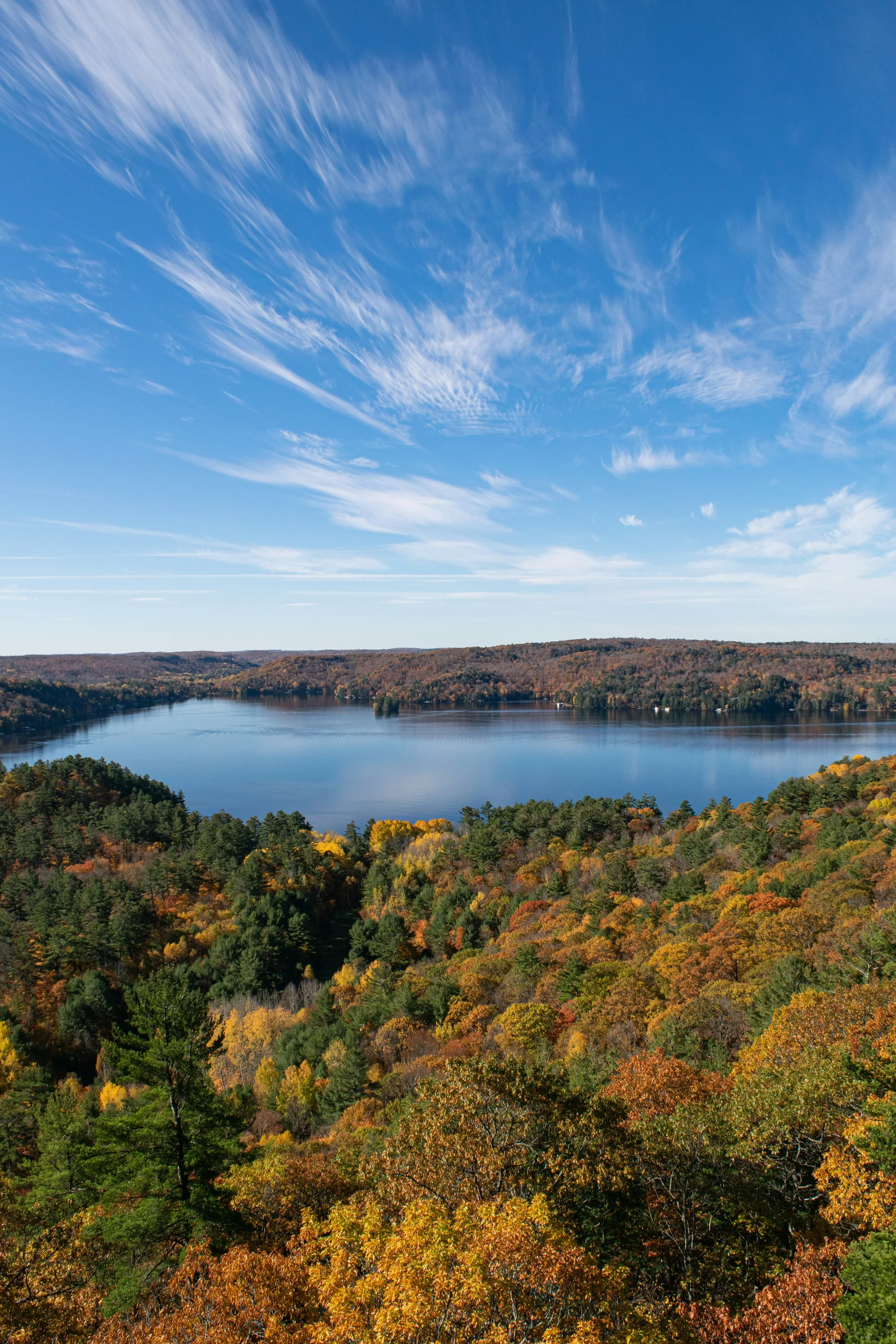 Aerial view of fall foliage around a lake near Bracebridge