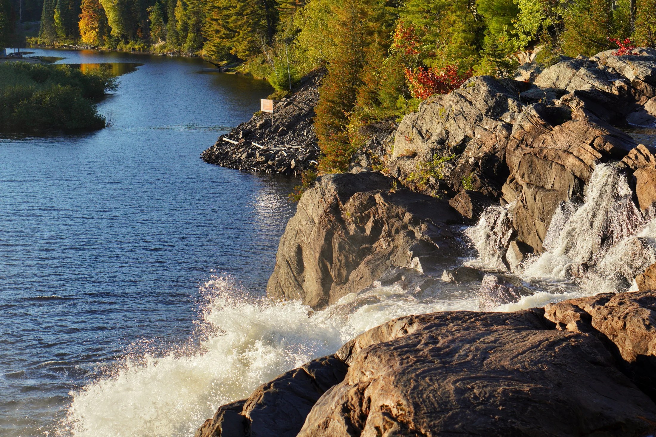 Bracebridge Falls in daylight, with spray rising off the rocks