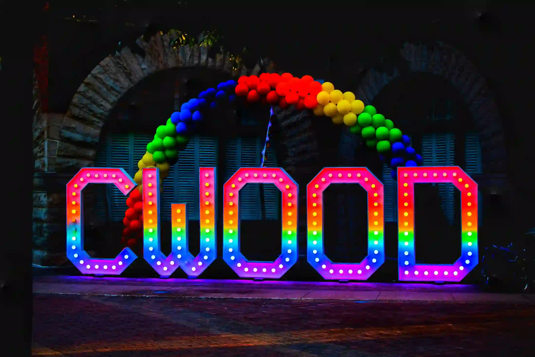 A lit-up downtown Collingwood sign at a summer evening event
