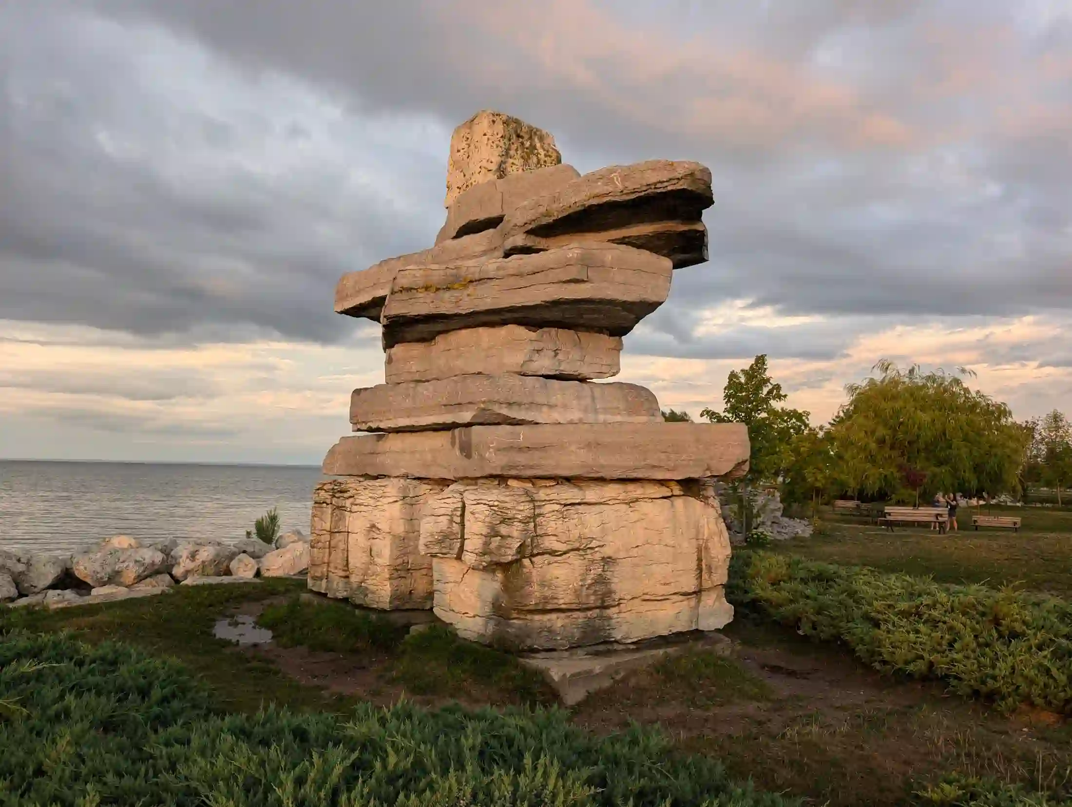 Stone cairn sculpture on Collingwood's harbourfront at dusk