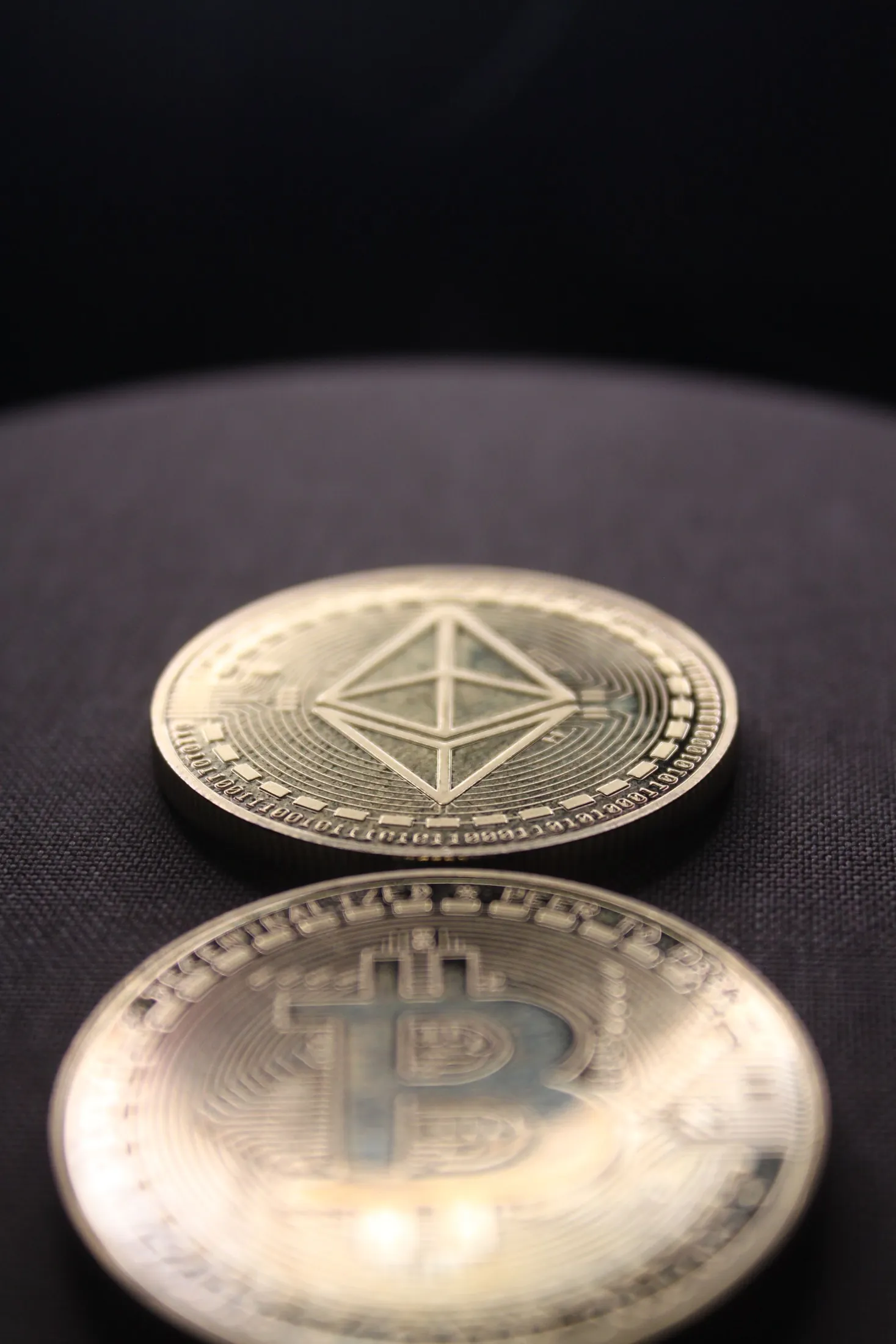 Ethereum and Bitcoin coins on a dark surface