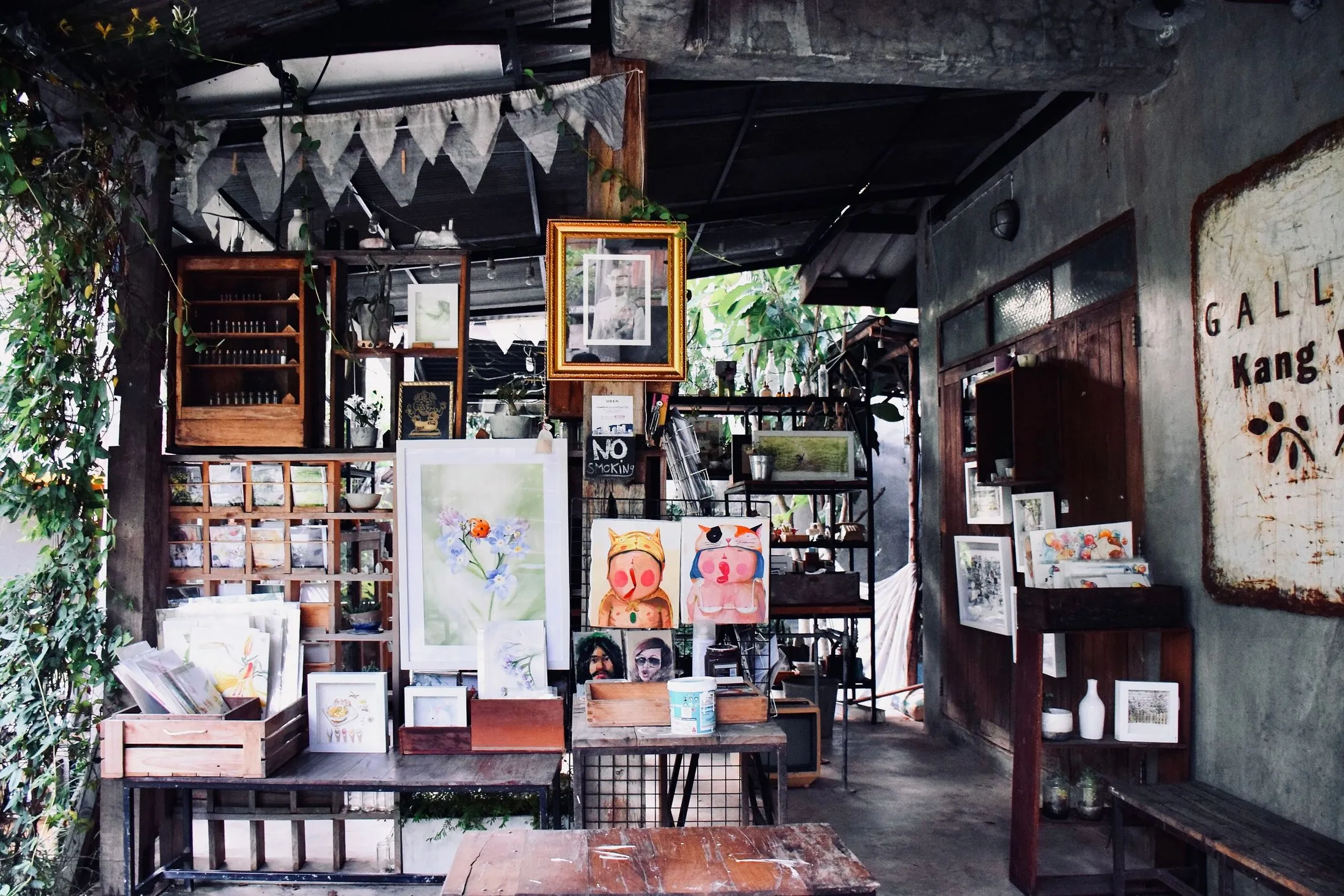 A small art shop filled with paintings and prints