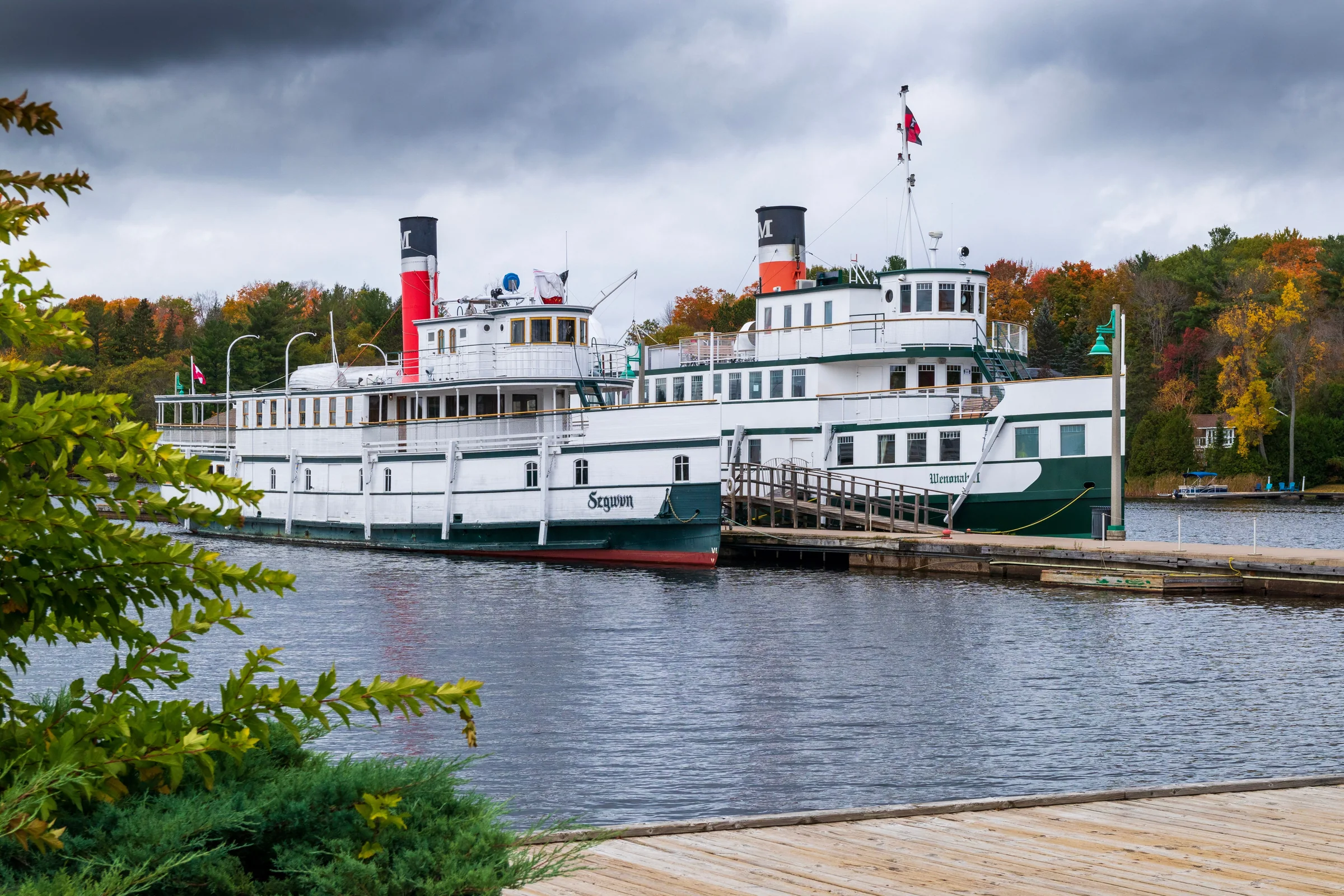The historic steamships RMS Segwun and Wenonah II docked side by side in Gravenhurst
