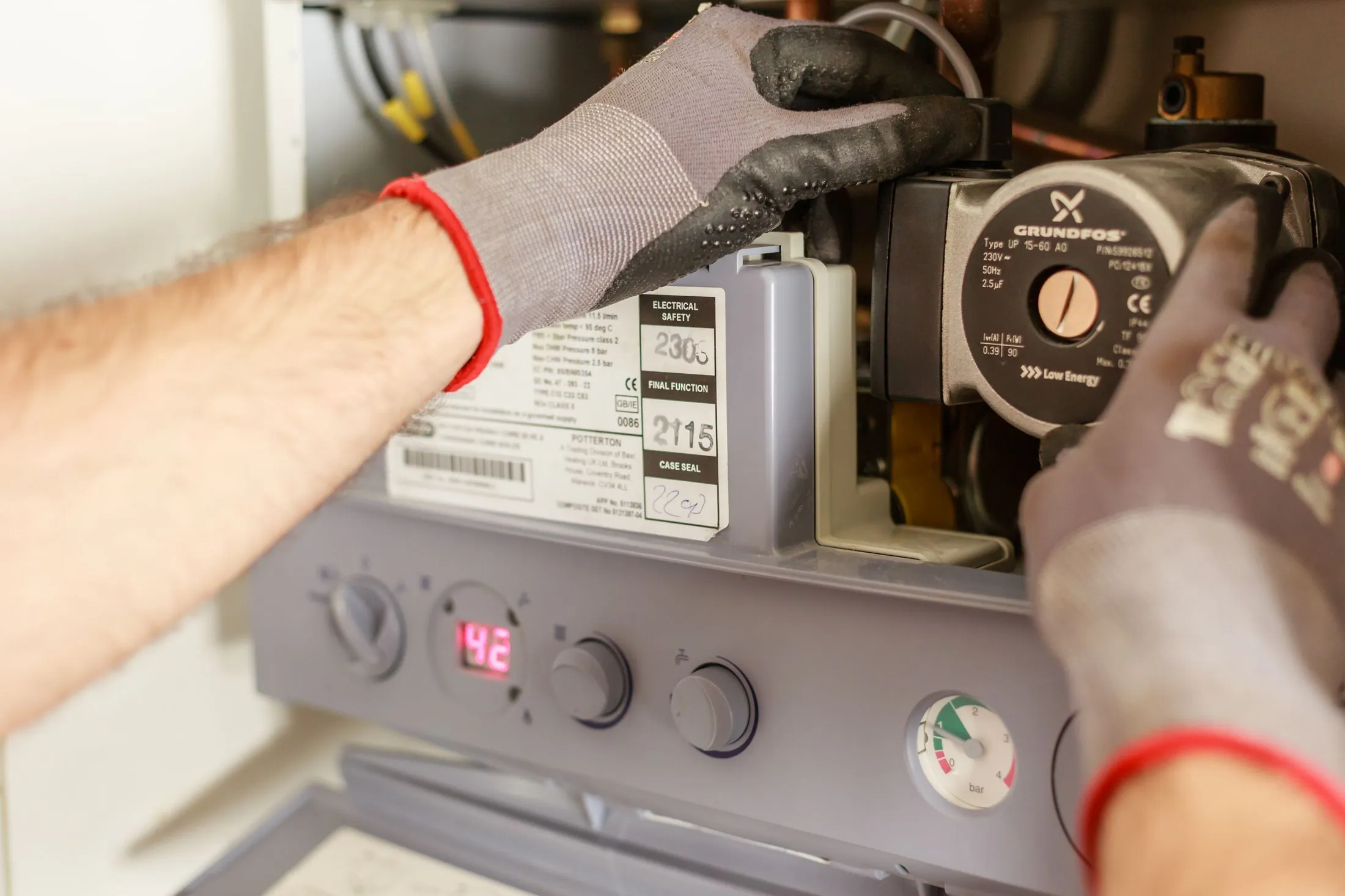 A technician adjusting a home boiler