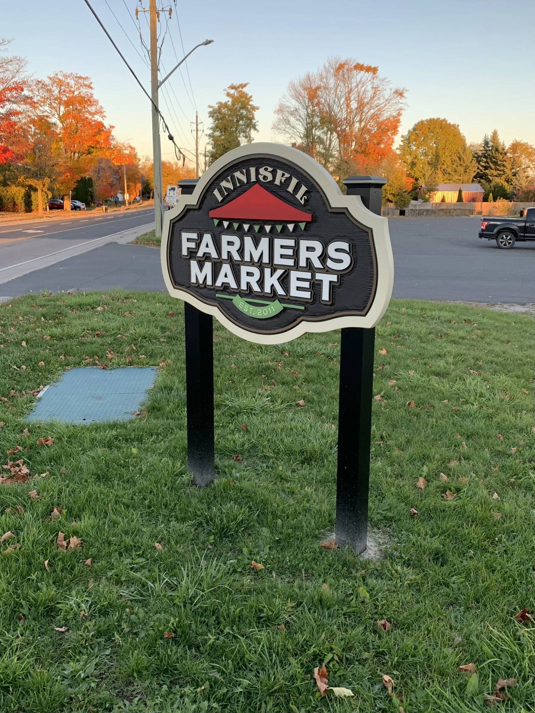 The Innisfil Farmers Market sign on a fall evening