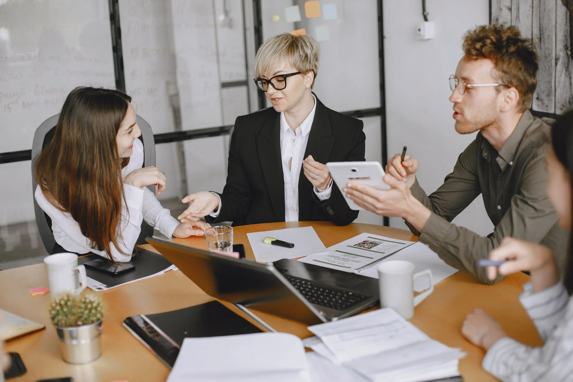 Colleagues around a conference table, talking through a plan
