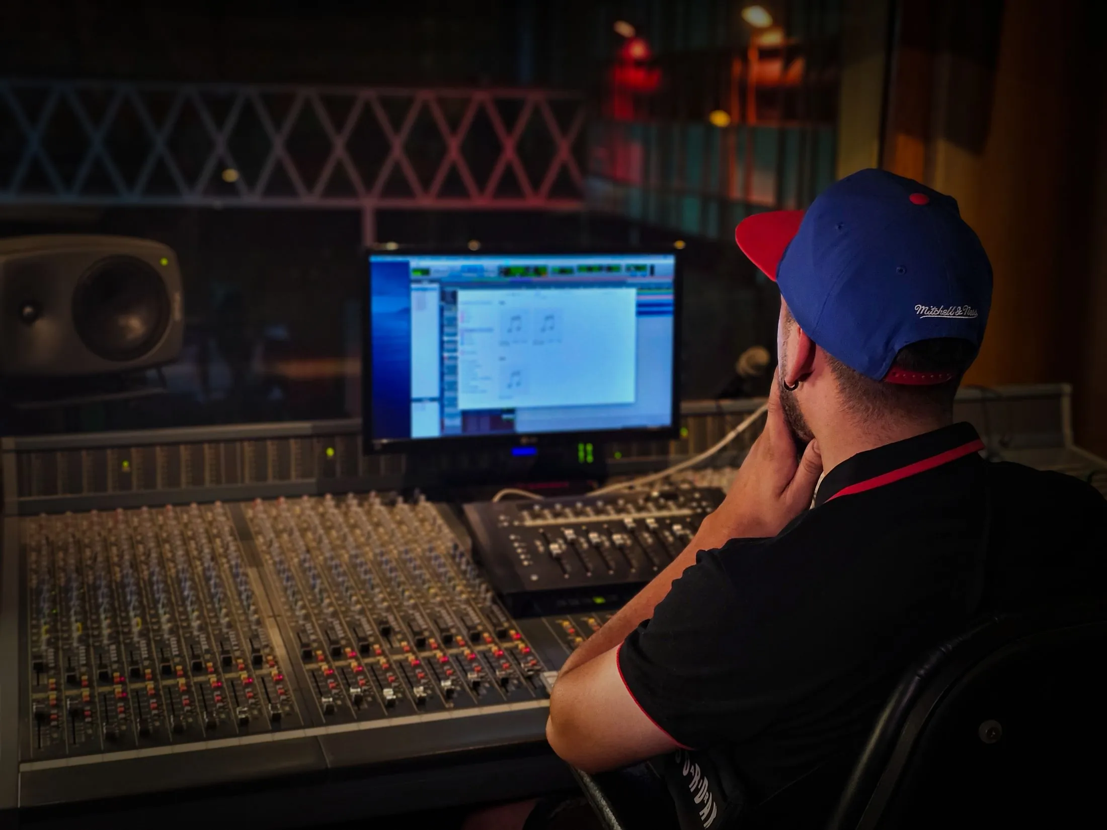 An engineer at a mixing console in a recording studio