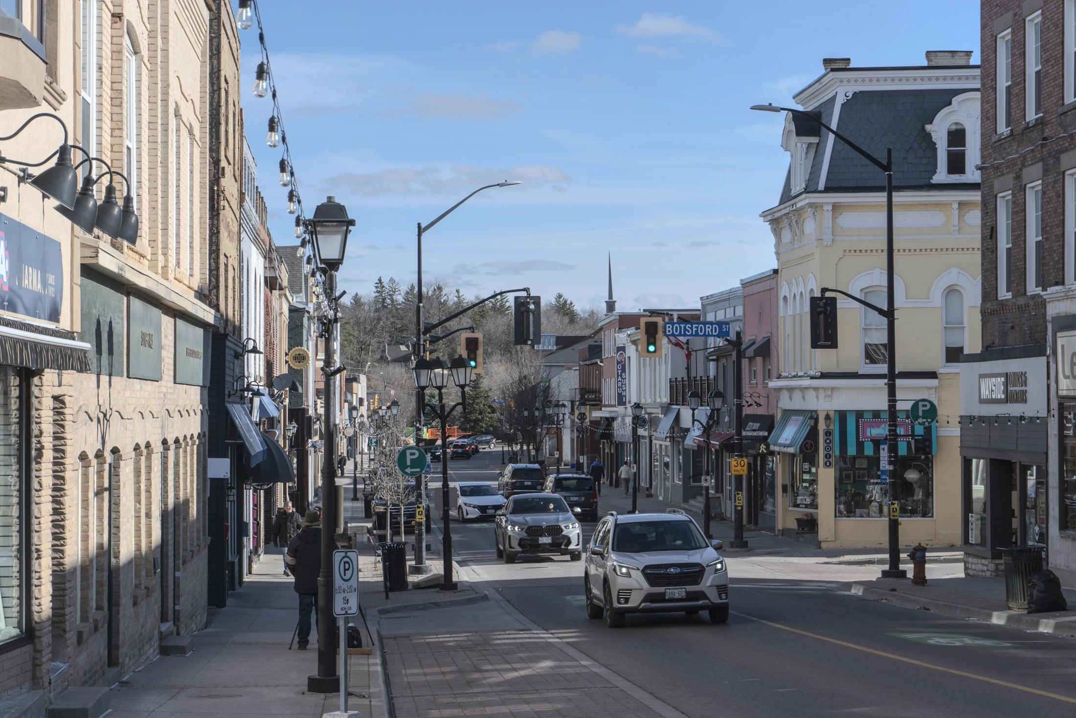 Botsford Street in downtown Newmarket lined with heritage storefronts and string lights