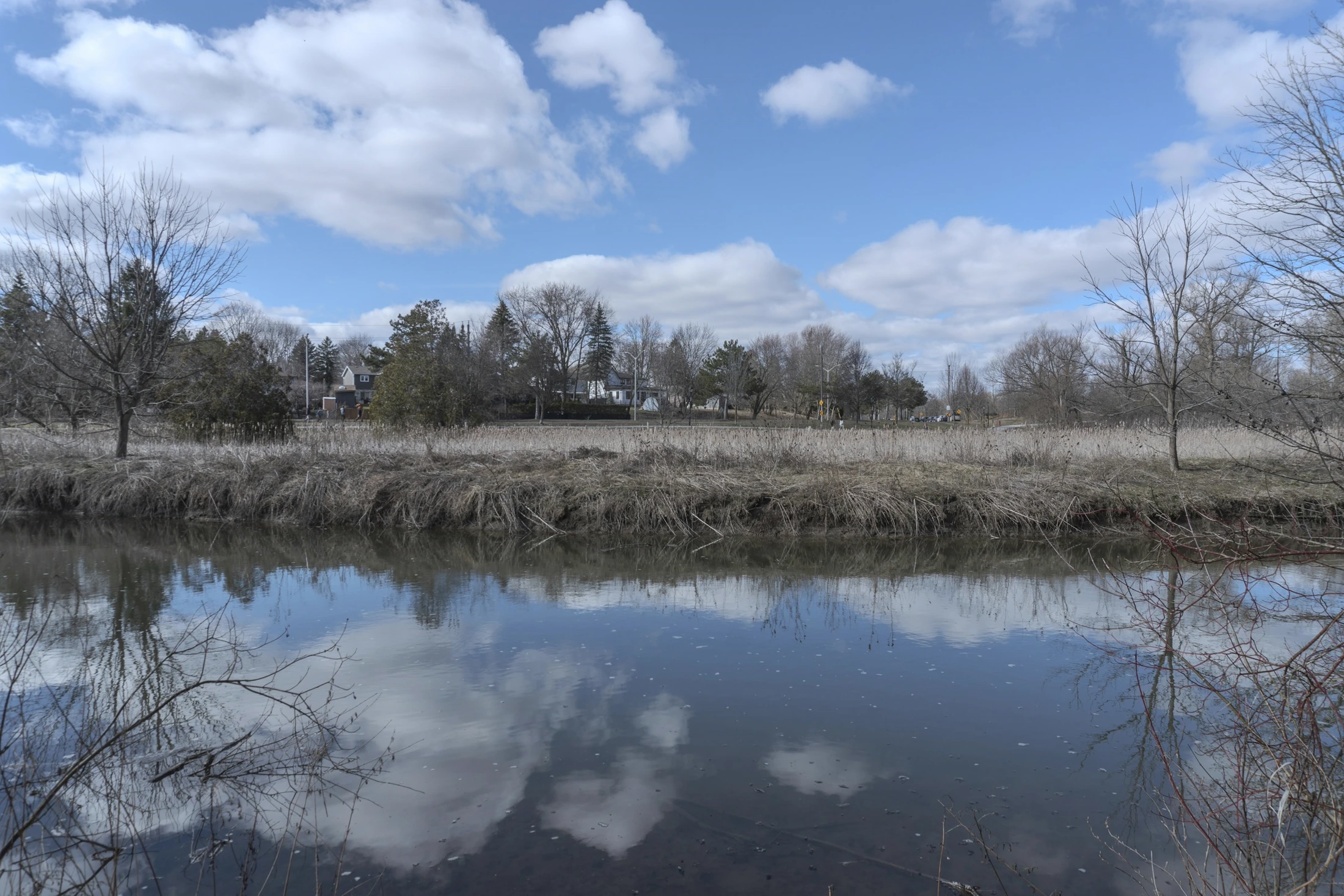 The Holland River reflecting the sky near Newmarket in early spring