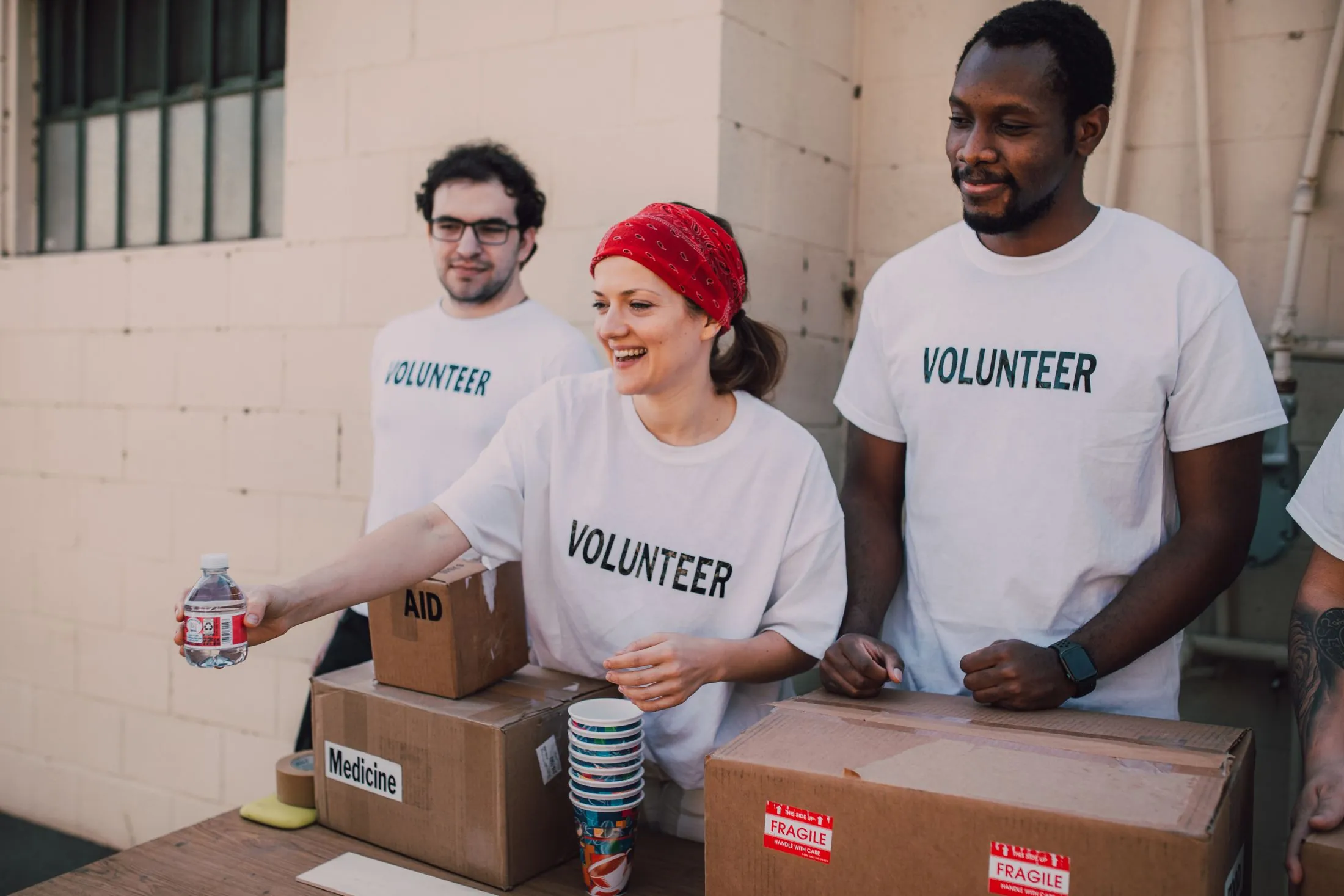 Volunteers handing out donations at an outdoor table