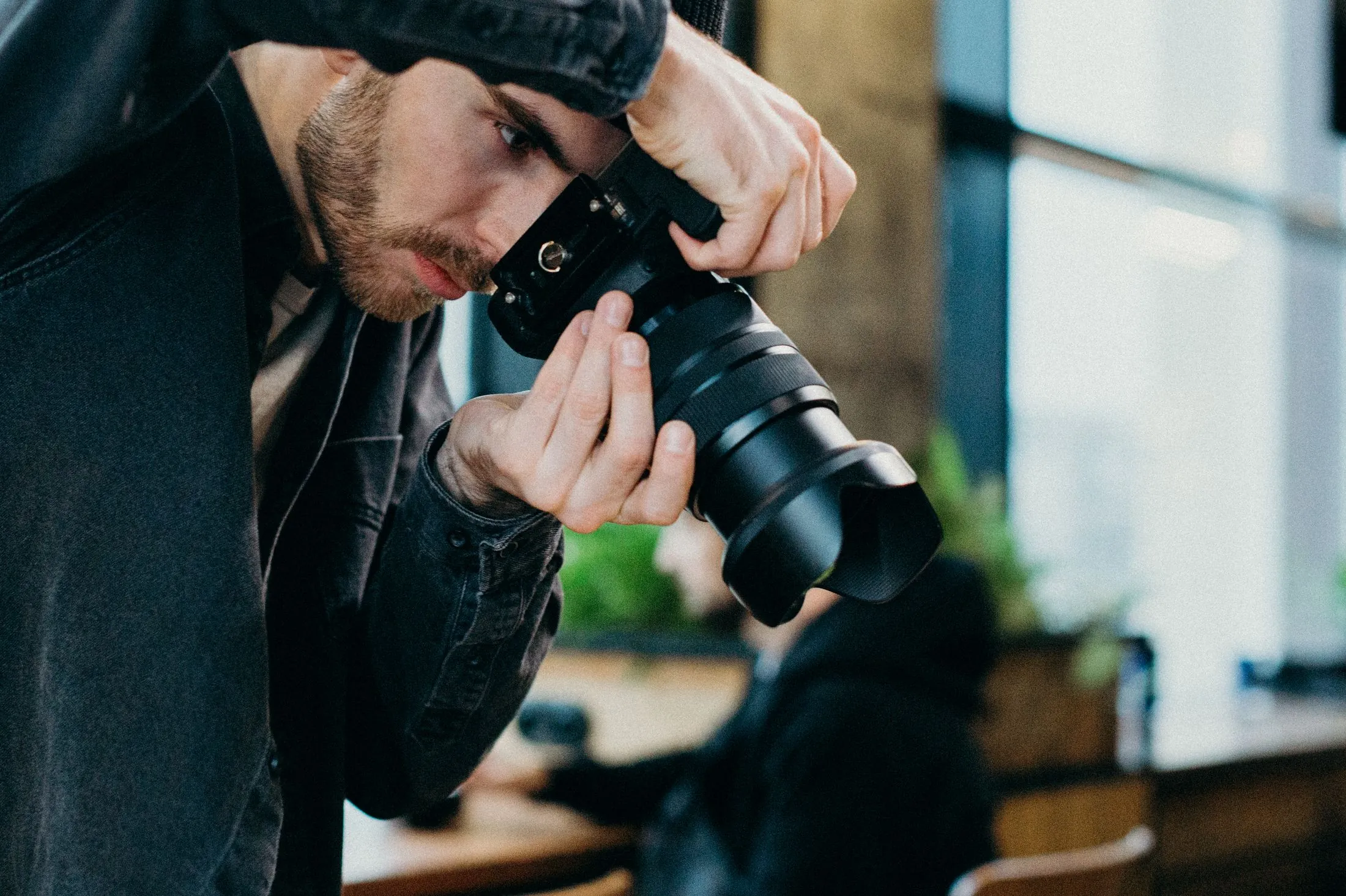 A photographer lining up a shot with a DSLR