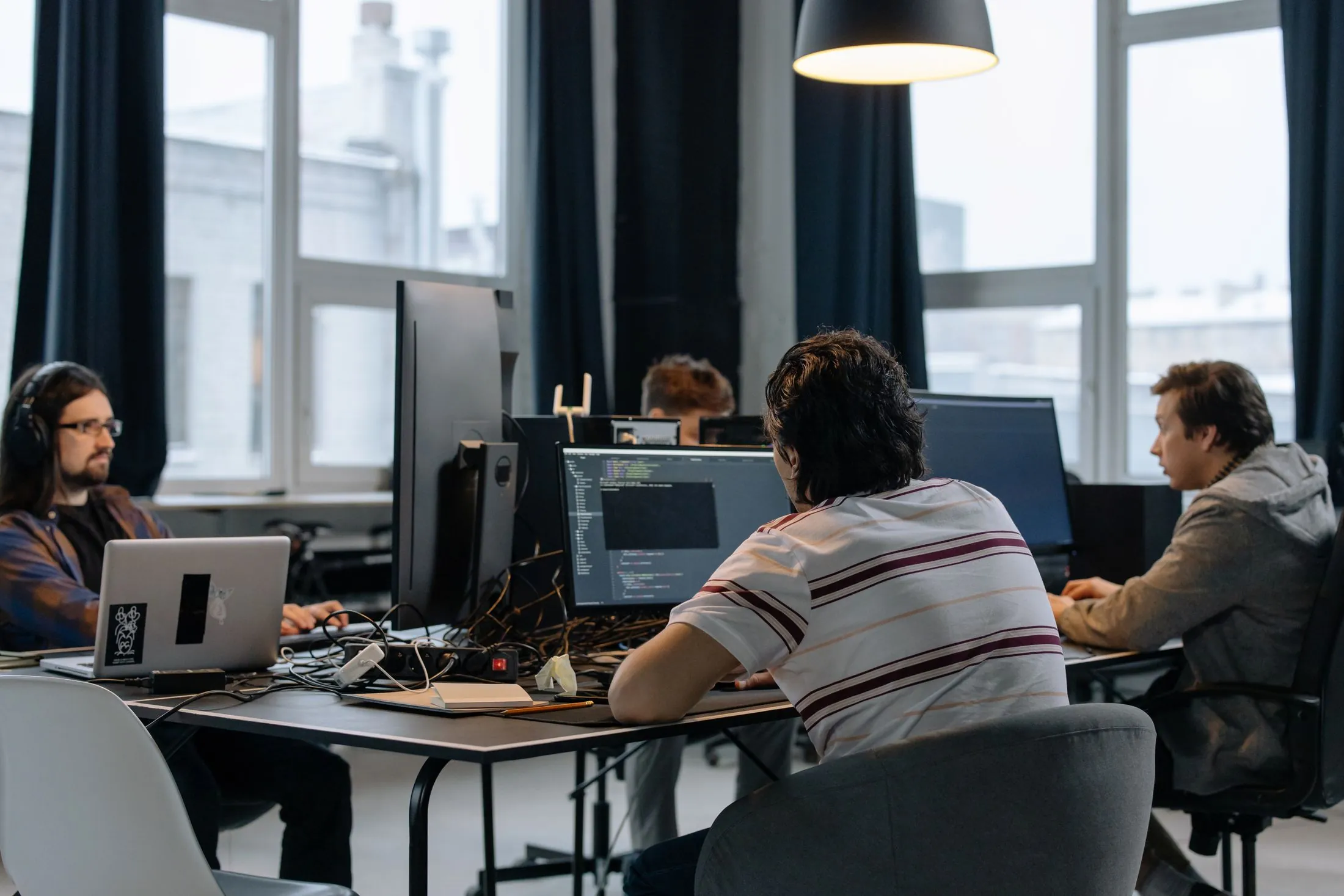 A software team at work at their desks in a bright office