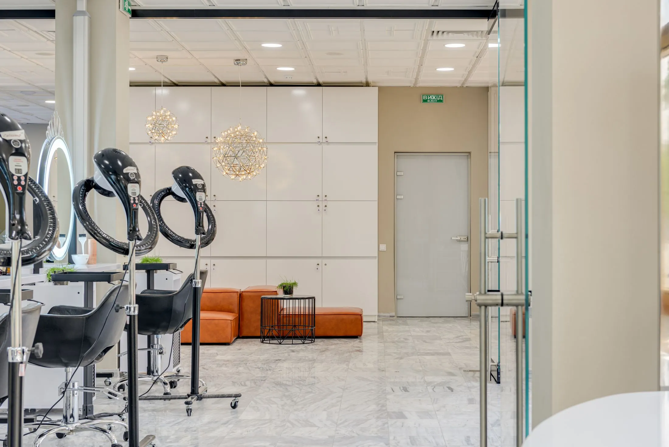 A bright salon with styling chairs, mirrors and marble floors