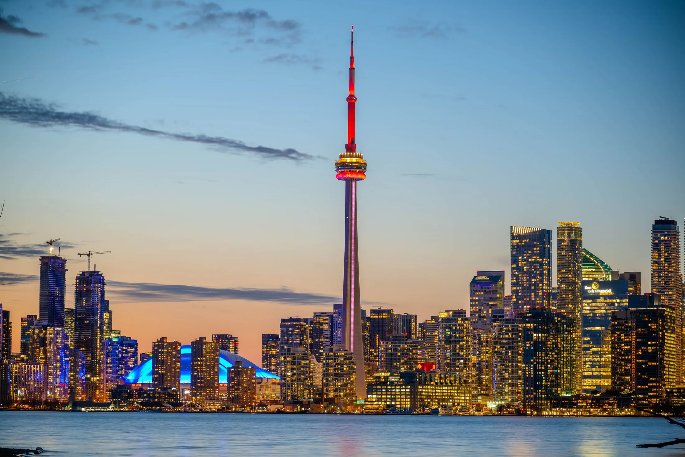 The CN Tower and the Toronto skyline lit up at sunset