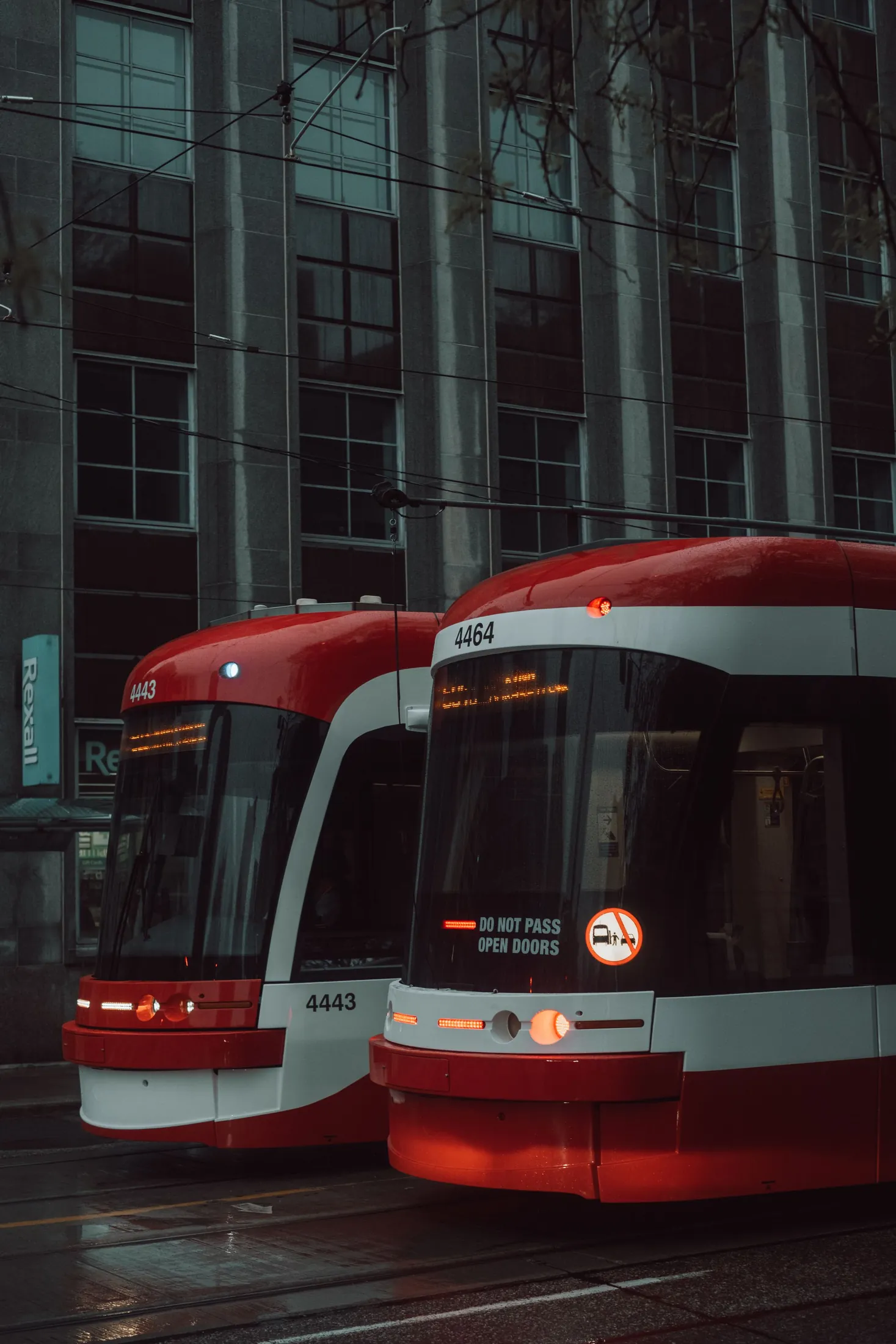 Two red streetcars on a downtown Toronto street